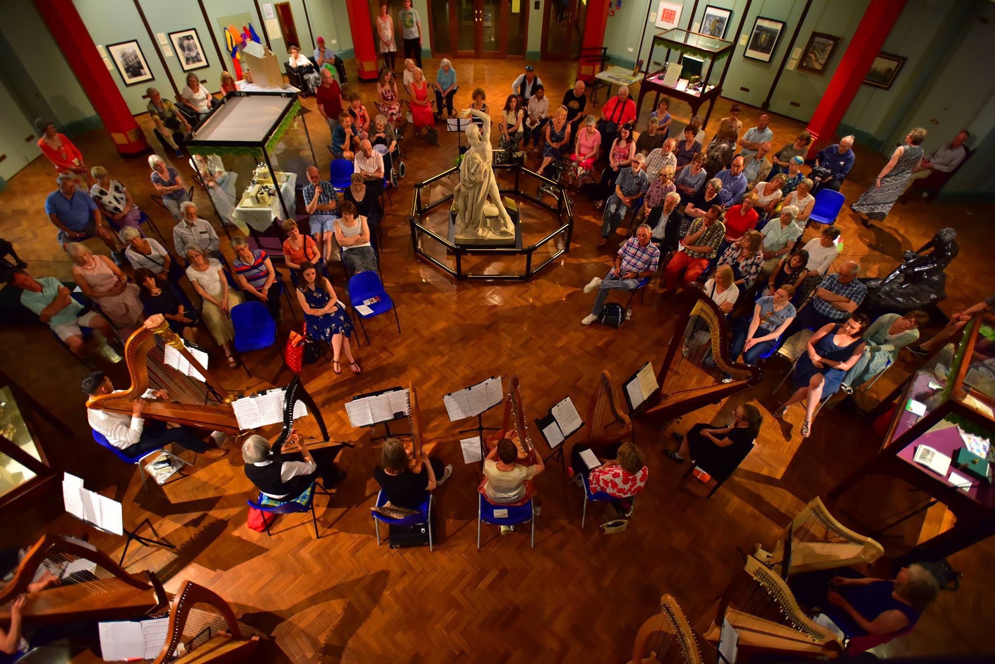 photograph of a concert by a group of harpists at Cliffe Castle Museum